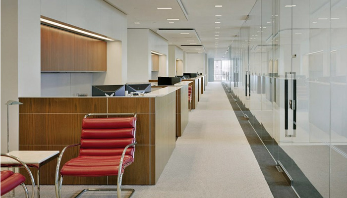 AutoStrada® workstations with transaction counters. MR Lounge Chair and Florence Knoll End Table in foreground